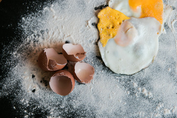 eggs and eggshell with flour - obrazy, fototapety, plakaty