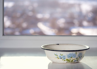 A bowl on a window
