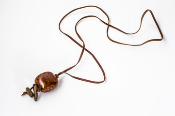 Pendant made with ceramics bead and leather straps isolated on a white background