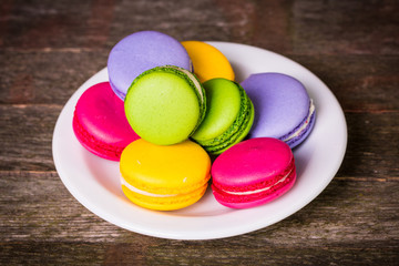 Fresh macaroons on wooden table ,vintage filter