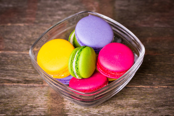 Fresh macaroons on wooden table ,vintage filter