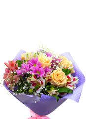Spring bouquet with cream roses, pink chrysanthemum ,  in packing paper purple color on a white background