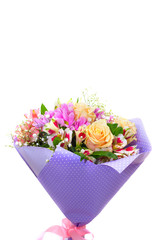 Spring bouquet with cream roses, pink chrysanthemum ,  in packing paper purple color on a white background