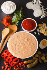 Thousand Island Dressing with ingredients close-up. vertical
