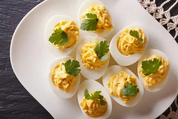 Gordijnen Stuffed eggs with mustard and parsley close-up. Horizontal top view   © FomaA