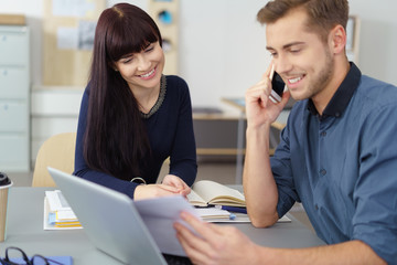 junges team telefoniert und schaut auf unterlagen