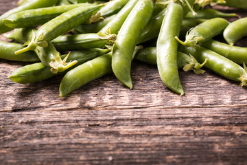 green peas on wooden table ,healthy concept