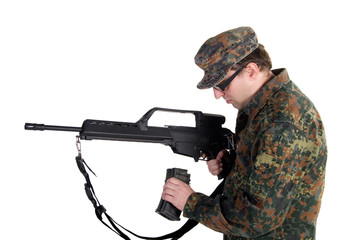 Soldier reloading a gun (isolated on white)