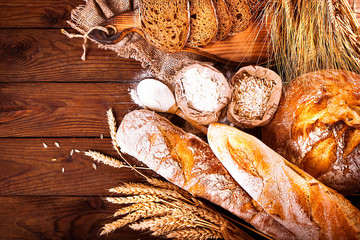 Homemade bread on wooden background. Country style. Food baking background