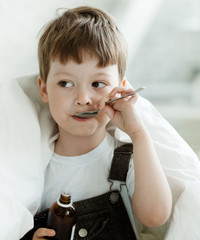 boy drinking cough syrup