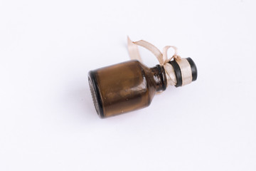 Small brown potion bottle with ribbon closeup