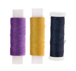 three spools of thread on white
