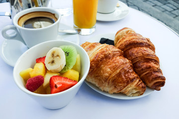 Breakfast with coffee and croissants on table