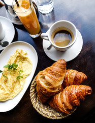 Breakfast with coffee and croissants on table