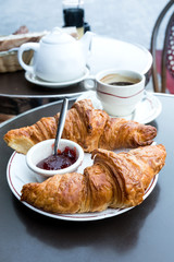 Breakfast with coffee and croissants on table