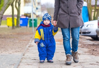 Little boy walking with his mother