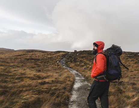 Man with backpack on footpath, Isle of Skye, Scotland