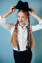 Smiling girl with long blonde hair on blue background