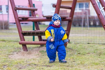 Little boy playing outdoor on city playground