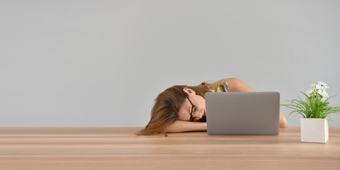 Woman falling asleep in front of laptop