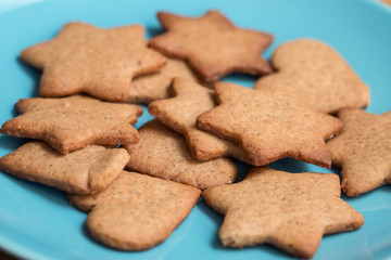 Tasty homemade ginger cookies on a blue plate. Shallow dof