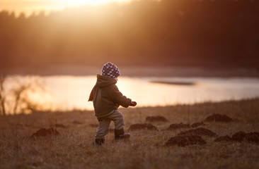 Little boy playing outdoor near lake
