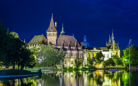 night view of the illuminaed vajdahunyad castle in varosliget parc in budapest.
