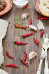 garlic and red pepper on brown wooden background