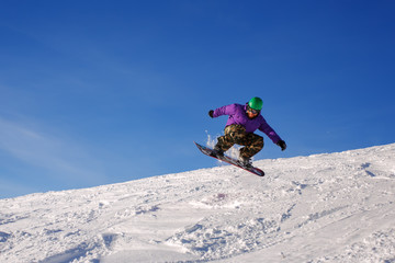 Naklejka na ściany i meble Snowboarder jumping