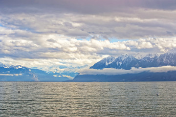 Fototapeta na wymiar Lausanne quay of Geneva Lake and mountains in Switzerland