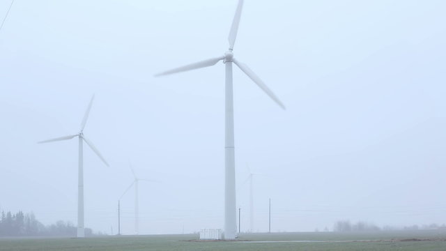 windmills near the road foggy morning. 