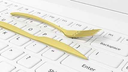 Golden fork and knife on laptop keyboard, conceptual background.