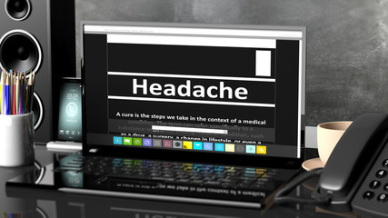 Laptop with Headache  information on screen, on desktop with office objects.
