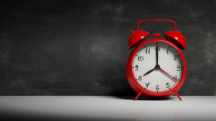 Retro red alarm clock with blackboard and copy-space