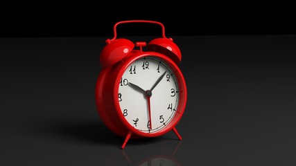 Retro red alarm clock, isolated on black background.