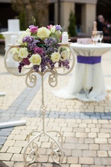 Beautiful stylish flower stand at wedding aisle closeup