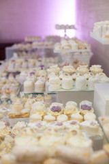 Delicious & tasty white decorated cupcakes at wedding reception
