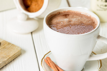 Hot Chocolate in White Beautiful Cup on Light White Wooden Background, Close-up, Horizontal