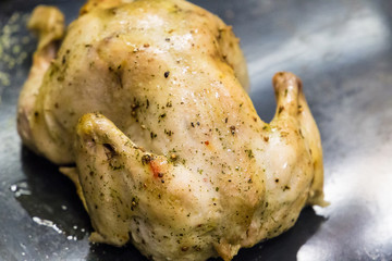 Roasted Beautiful Chicken with Spices on Gray Background, Close-up