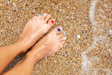 Vacation holidays. Woman feet closeup of girl relaxing on beach