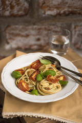 Spaghetti with roasted tomatoes and basil leafs