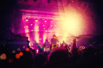 Silhouettes of people and musicians in big concert stage