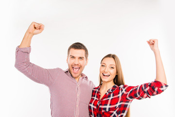 Smiling couple in love with raised hands