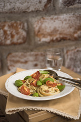 Spaghetti with roasted tomatoes and basil leafs
