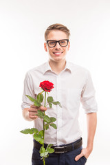 Handsome  man in glasses with a red rose holding hand in pocket