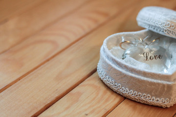 Glass Heart in a white soft box on the wooden background
