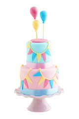 Fondant covered pastels coloured birthday cake with buntings and balloons iolated on white