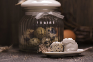 Glass jar with quail eggs. Easter greeting card. Spring concept. Toned image. Selective focus