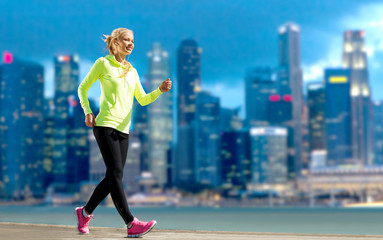 happy woman jogging over city street background