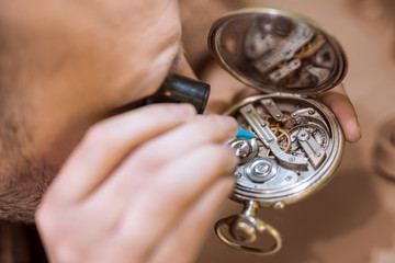 Close up  portrait of a watchmaker at work